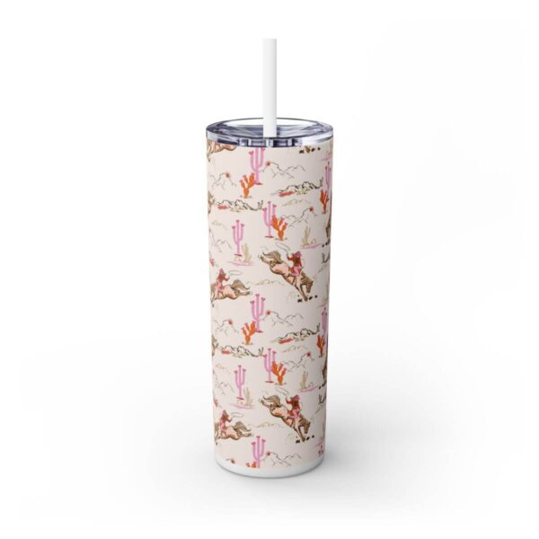 Front view of the Cowgirl Skinny Tumbler featuring a bucking horse, pink cacti, and mountain designs in vibrant colors, with a clear lid and matching straw, perfect for stylish hydration.